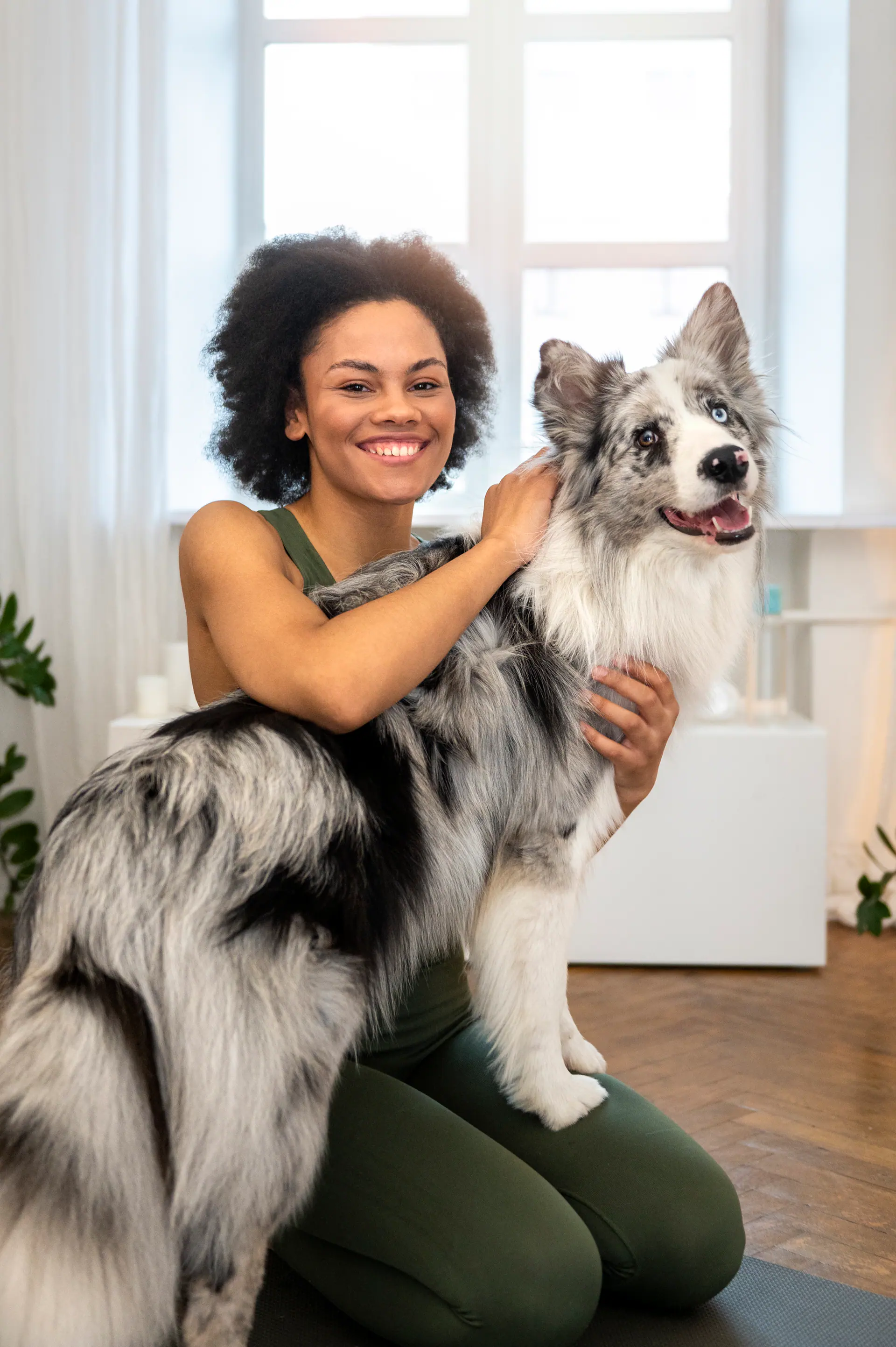 A person exercising at home with their pet nearby